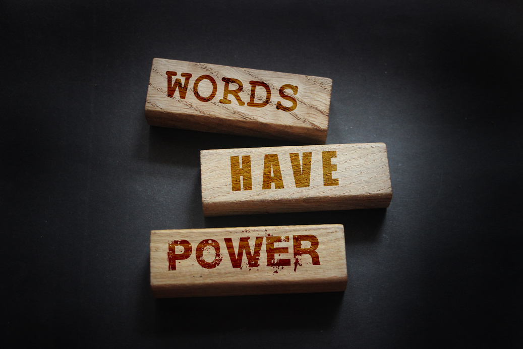 The phrase Words Have Power on wooden blockslaying on black background. Copywriting advertising piar concept